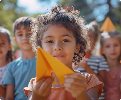 Child enjoying activities at the event Child holding a paper craft at a community event